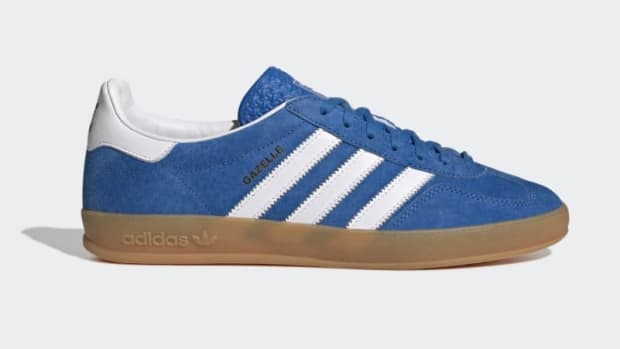 Side view of blue and white adidas sneakers.